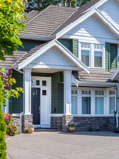 Beautifully painted modern house with green and white accents, showcasing professional exterior painting services by Bay Breeze Painting Company.