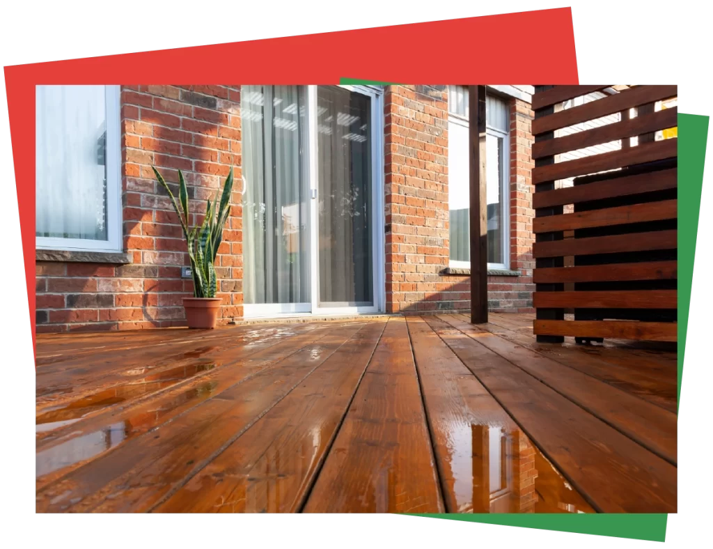 Beautifully restored wooden deck with a glossy finish, set against a brick house exterior, showcasing Bay Breeze Painting Company's deck restoration services.