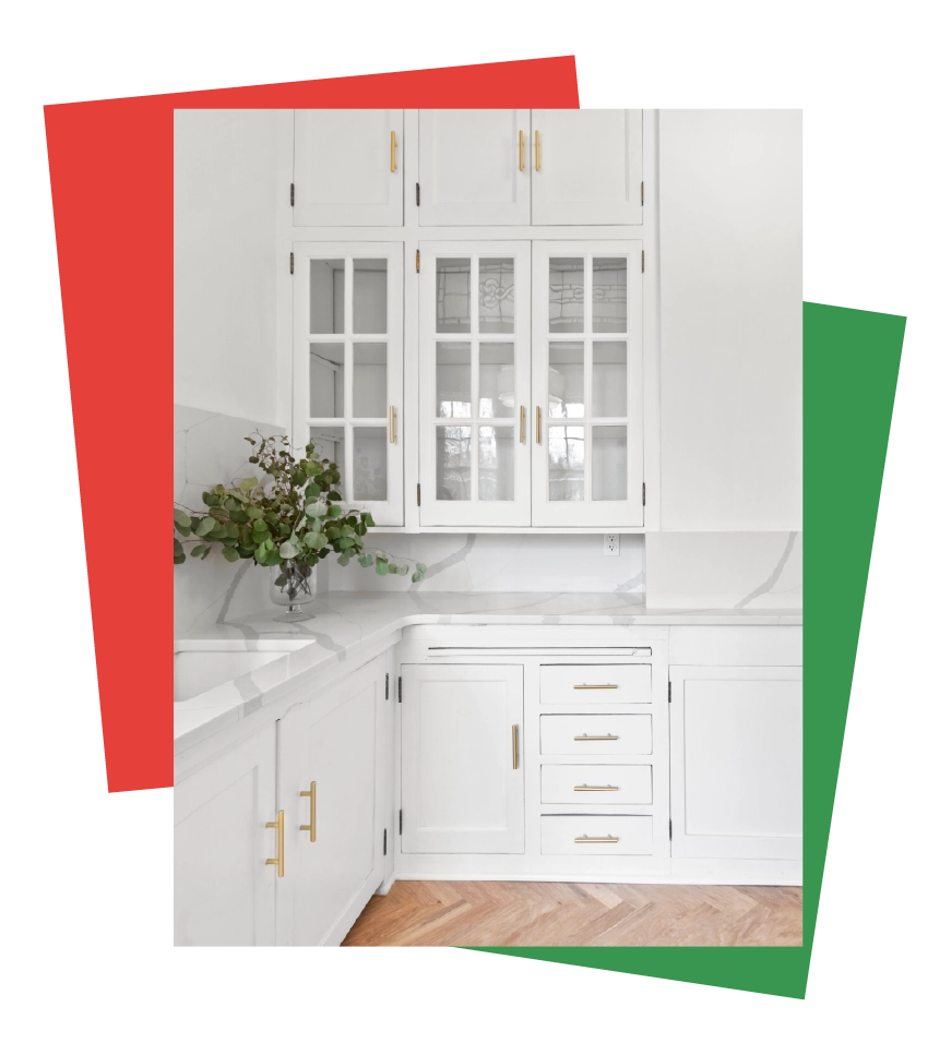 Bright kitchen with refinished white cabinets, gold hardware, and a marble backsplash, featured in the hero section of Bay Breeze Painting Company's cabinet refinishing service page.