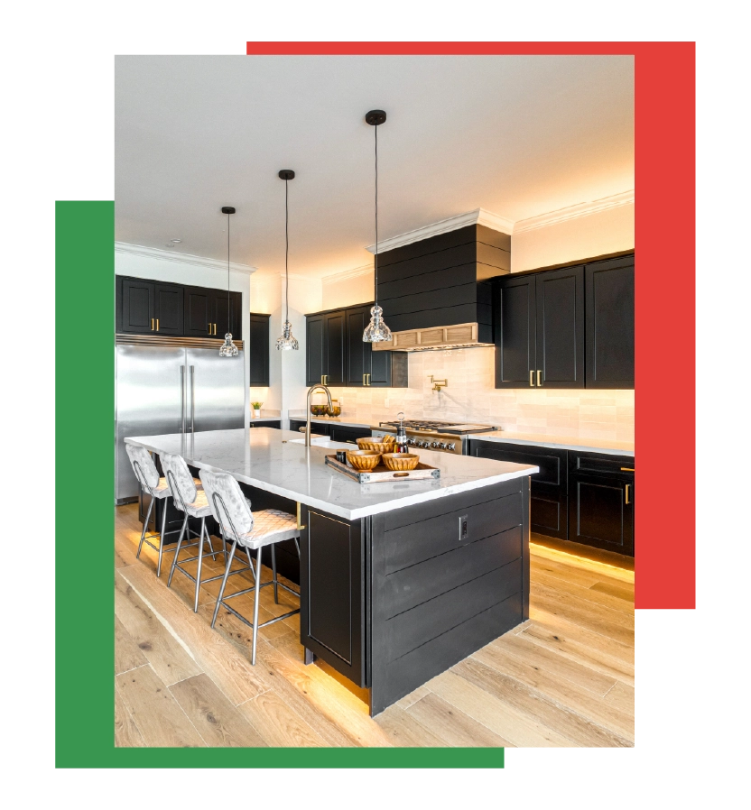 Modern kitchen with dark refinished cabinets, marble countertops, and elegant lighting, showcasing the transformation potential of cabinet refinishing by Bay Breeze Painting Company.