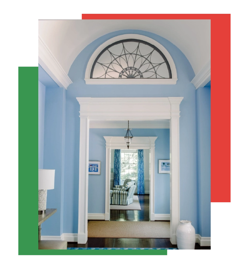 Restored historic entryway with blue door and white trim, featuring traditional millwork