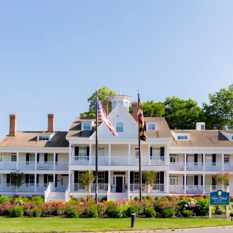 Large white waterfront resort-style building in Kent County, Maryland, surrounded by greenery